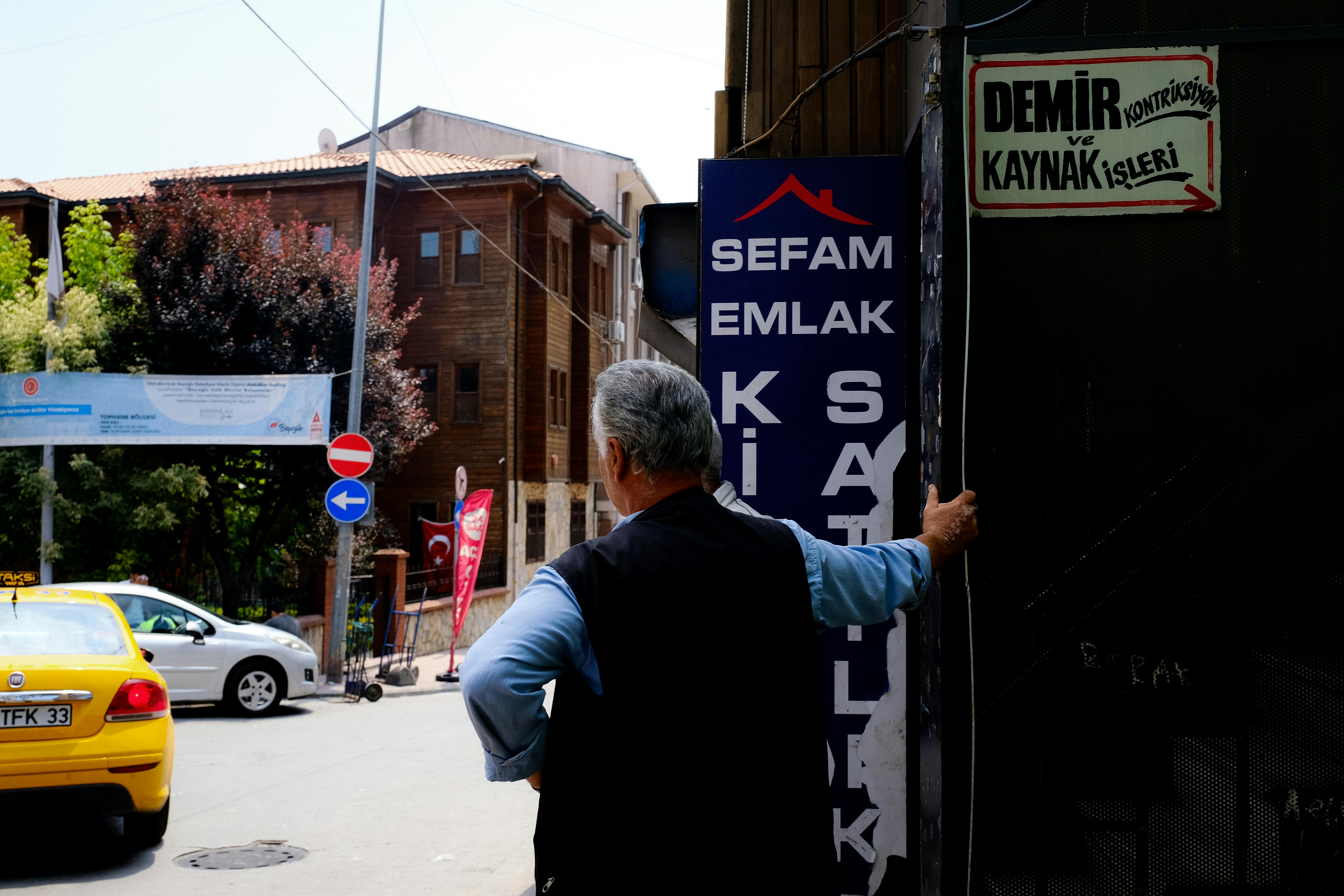 Two men standing near road talking